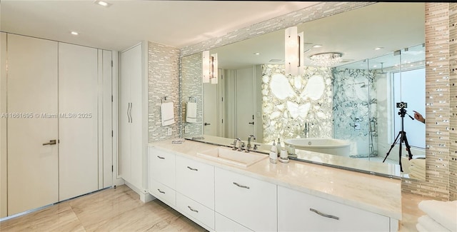 bathroom featuring a shower with shower door and vanity