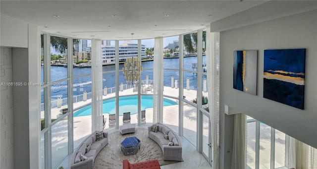 interior space with a water view and expansive windows