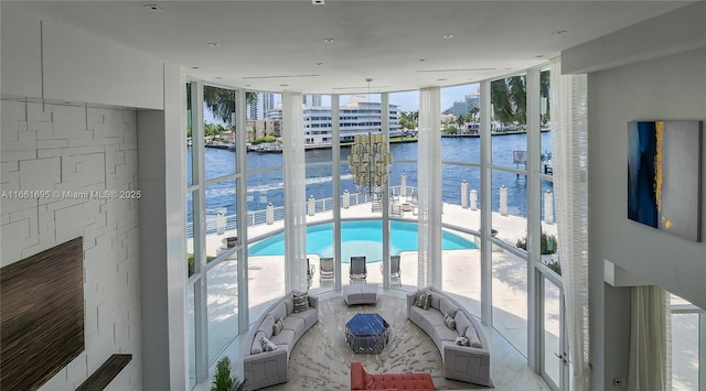 interior space with a wall of windows and a water view