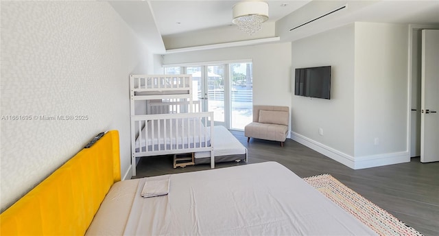 bedroom with dark hardwood / wood-style floors