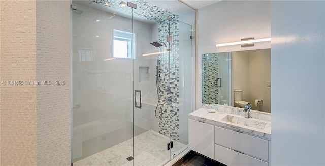 bathroom with toilet, vanity, tile patterned flooring, and a shower with door