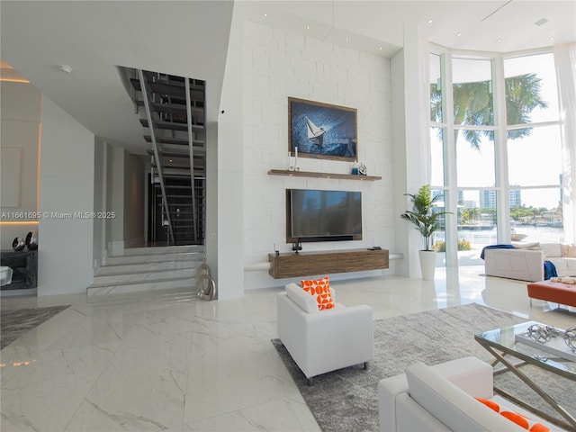 living room featuring a high ceiling and expansive windows