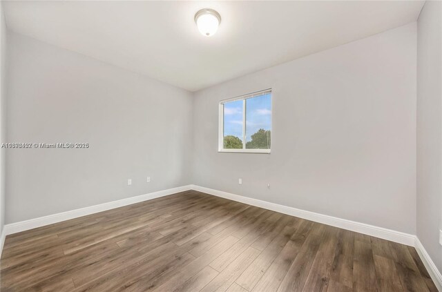 unfurnished bedroom featuring dark hardwood / wood-style floors and a closet