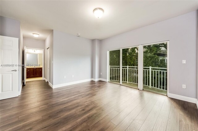 spare room with dark hardwood / wood-style floors