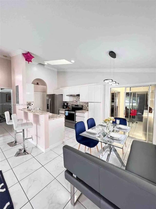 dining area featuring ornamental molding and lofted ceiling