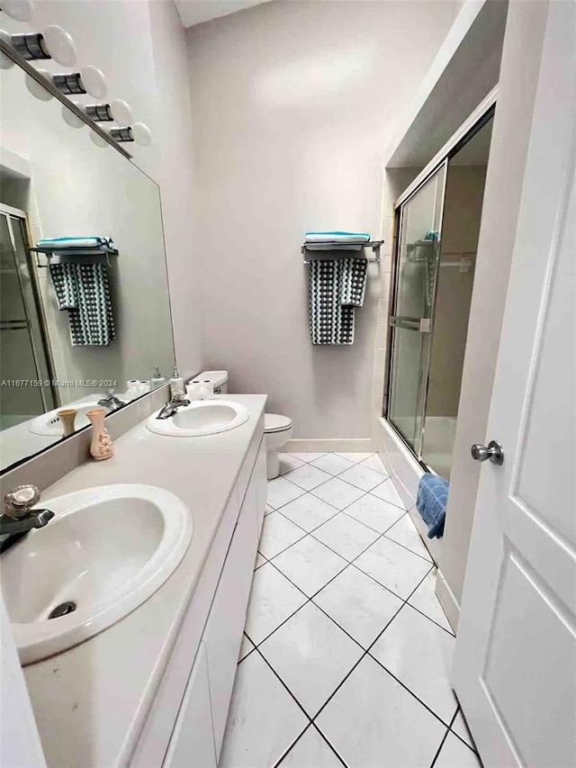 full bathroom featuring vanity, toilet, tile patterned floors, and shower / bath combination with glass door