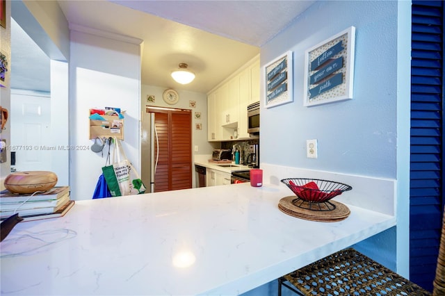 kitchen with white cabinetry and stainless steel appliances