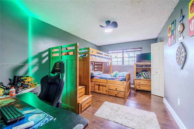 bedroom with hardwood / wood-style flooring and a textured ceiling