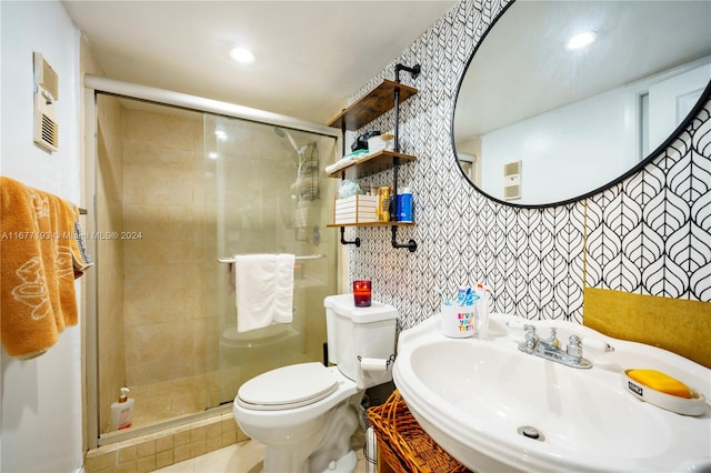 bathroom with a shower with door, toilet, and vanity