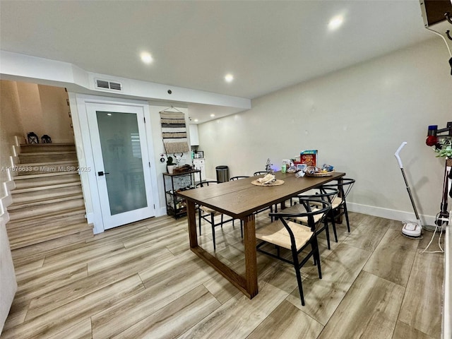 dining space with light hardwood / wood-style flooring