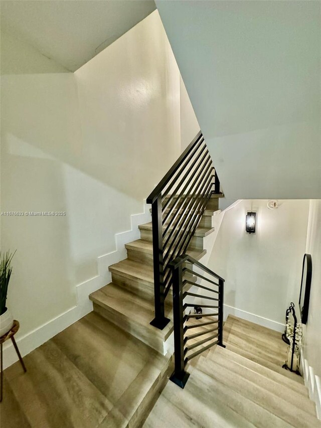 stairway featuring hardwood / wood-style floors