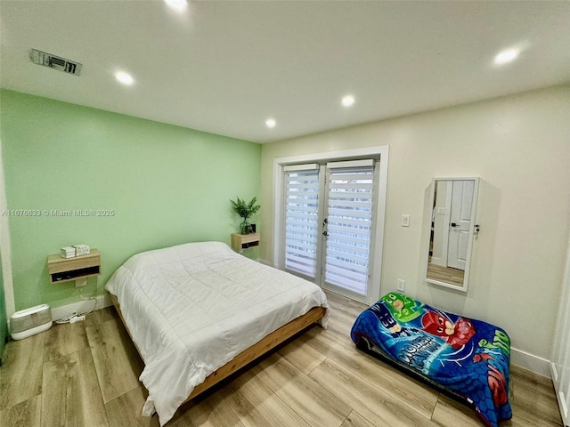 bedroom with light hardwood / wood-style flooring and access to outside