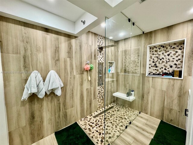 bathroom featuring tiled shower and hardwood / wood-style flooring