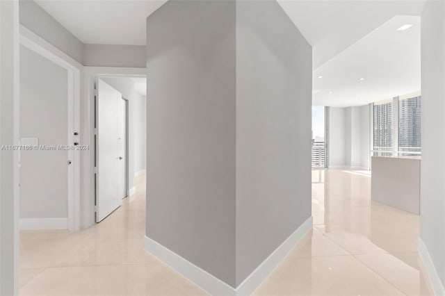 hall featuring light tile patterned flooring