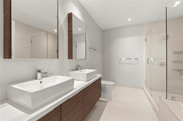 bathroom with vanity, toilet, tile patterned floors, and an enclosed shower