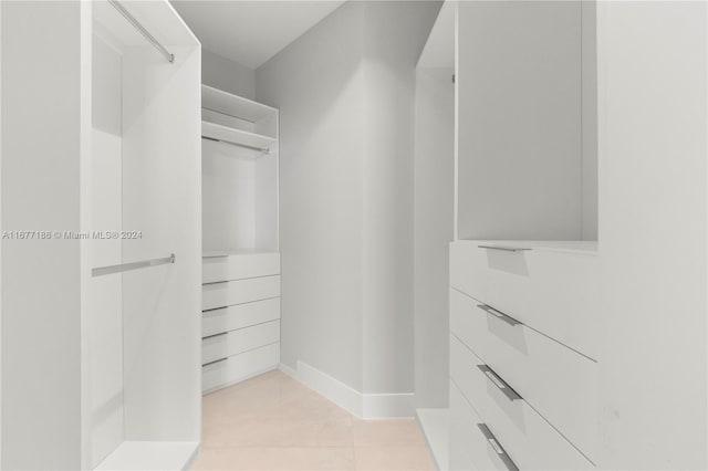 walk in closet with light tile patterned floors