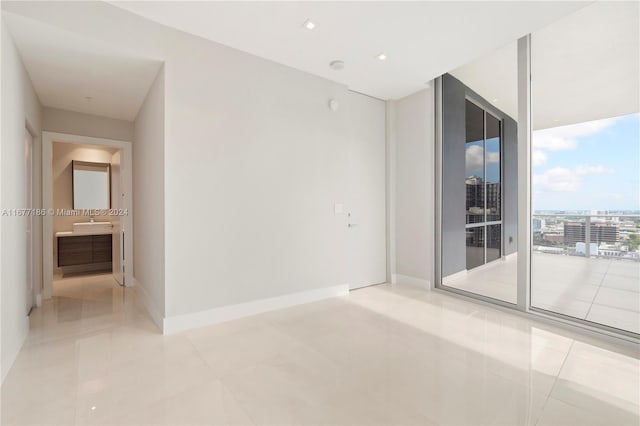 tiled spare room with expansive windows