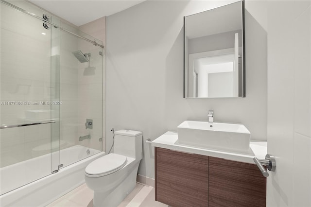 full bathroom featuring vanity, toilet, enclosed tub / shower combo, and tile patterned flooring