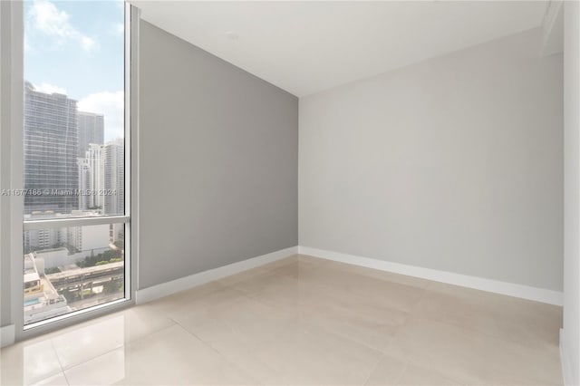 spare room featuring light tile patterned floors