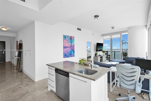 kitchen featuring dishwasher, a center island with sink, sink, stone counters, and white cabinets