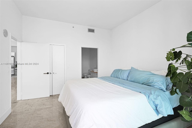 bedroom with a closet and ensuite bathroom