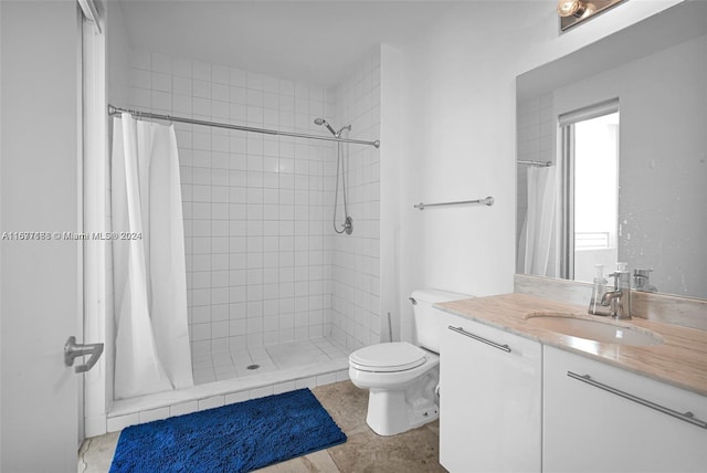 bathroom with vanity, curtained shower, and toilet