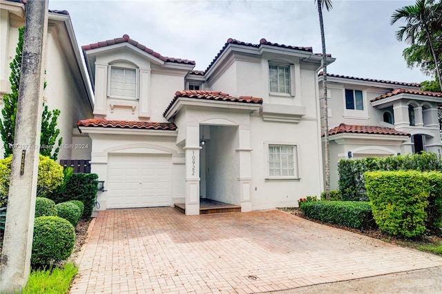 mediterranean / spanish-style house with a garage