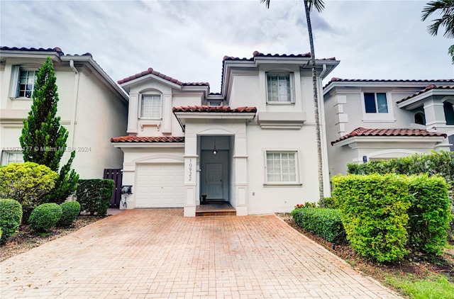 mediterranean / spanish-style house with a garage