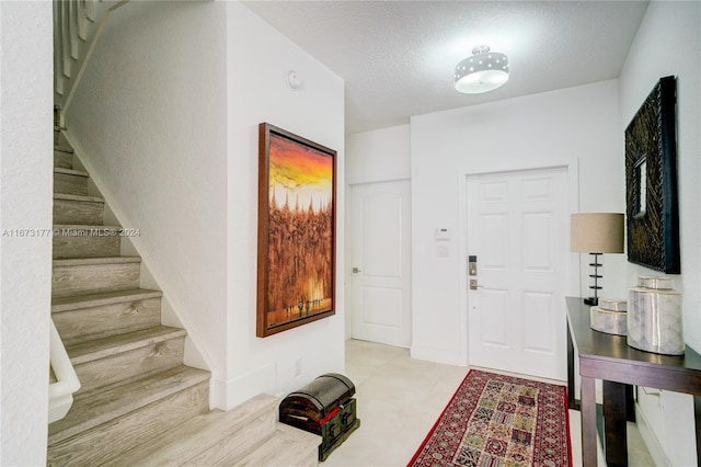 entryway with a textured ceiling