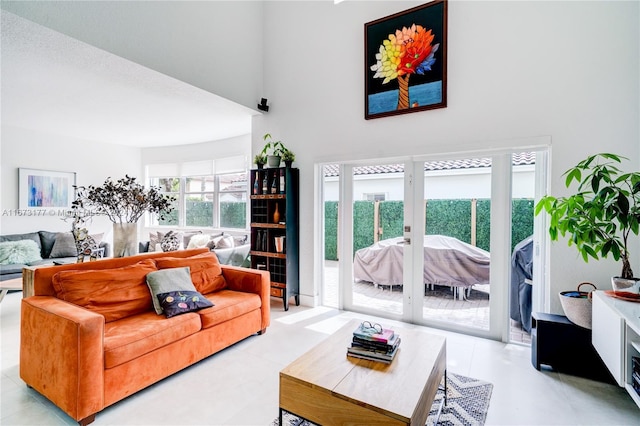 living room featuring a high ceiling and french doors