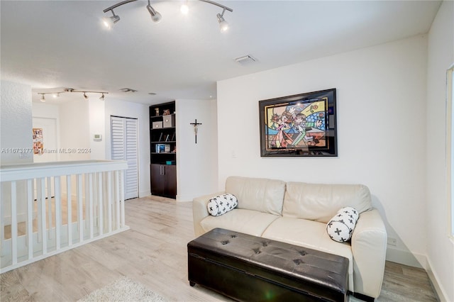 living room featuring track lighting and light hardwood / wood-style flooring