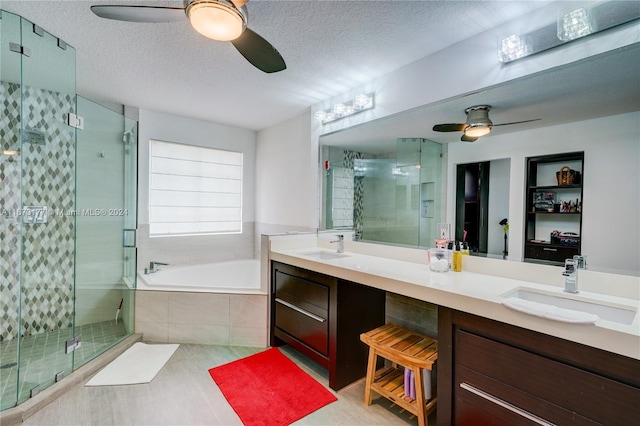 bathroom with vanity, shower with separate bathtub, a textured ceiling, and ceiling fan