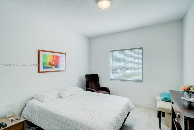 bedroom featuring light tile patterned floors