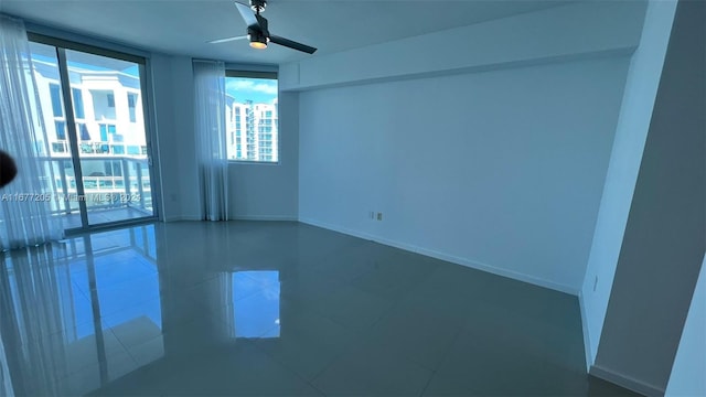 spare room featuring tile patterned flooring and ceiling fan