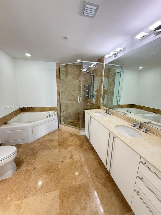 full bathroom with vanity, separate shower and tub, and toilet