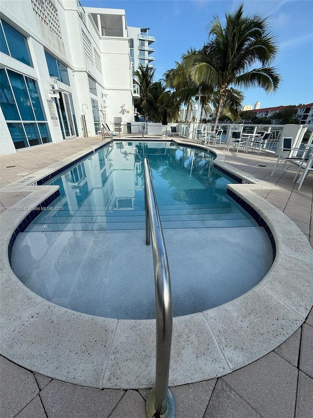 view of swimming pool with a patio