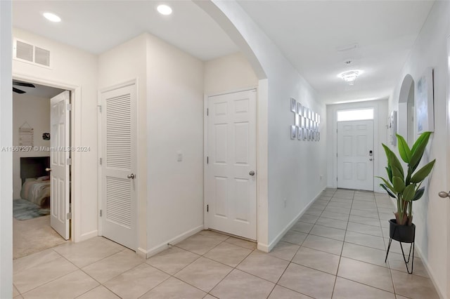 729 SW Lakehurst Dr, Port St Lucie, FL 34983 - corridor with light tile patterned floors, baseboards, arched walkways, and recessed lighting