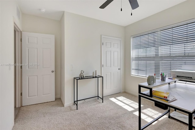 carpeted office featuring ceiling fan