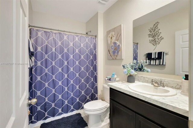729 SW Lakehurst Dr, Port St Lucie, FL 34983 - full bath featuring vanity, toilet, tile patterned floors, and a shower with shower curtain