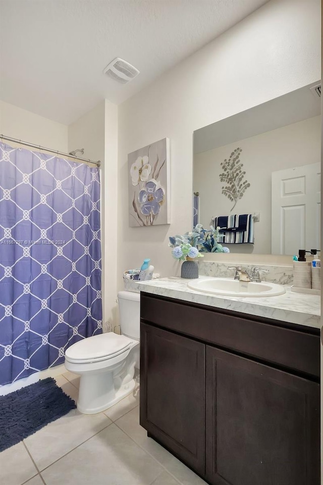 bathroom with vanity, toilet, tile patterned floors, and curtained shower