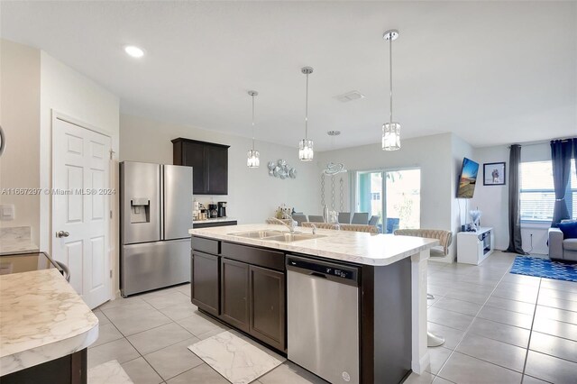 729 SW Lakehurst Dr, Port St Lucie, FL 34983 - kitchen with appliances with stainless steel finishes, a sink, open floor plan, light countertops, and light tile patterned flooring