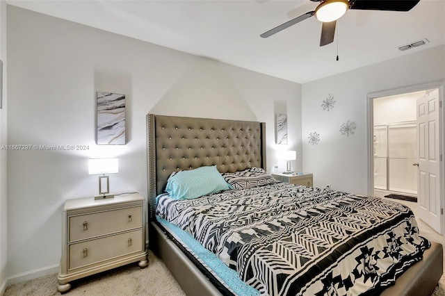 bedroom with light carpet, ensuite bath, and ceiling fan