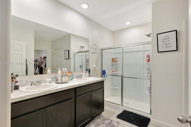 729 SW Lakehurst Dr, Port St Lucie, FL 34983 - full bath featuring a shower stall, double vanity, a walk in closet, and tile patterned flooring