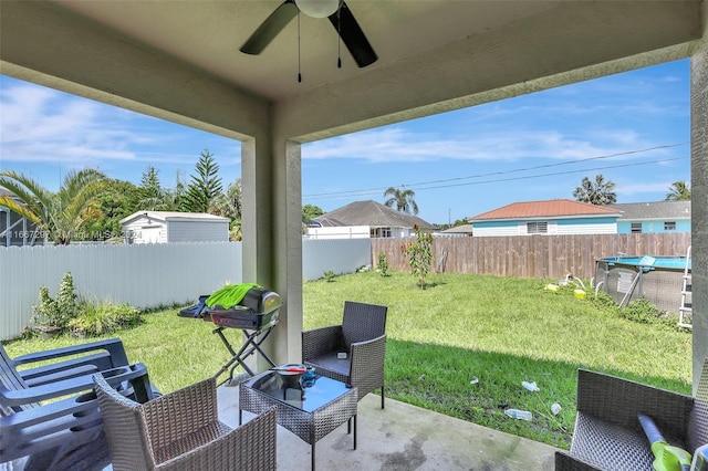 view of yard featuring a patio area and ceiling fan