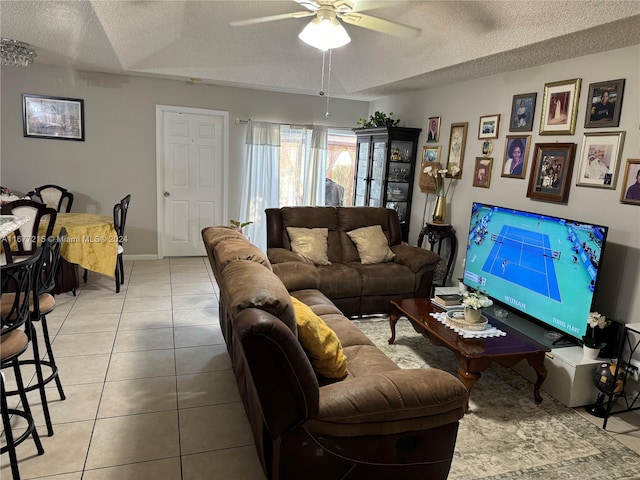 tiled living room featuring a textured ceiling and ceiling fan