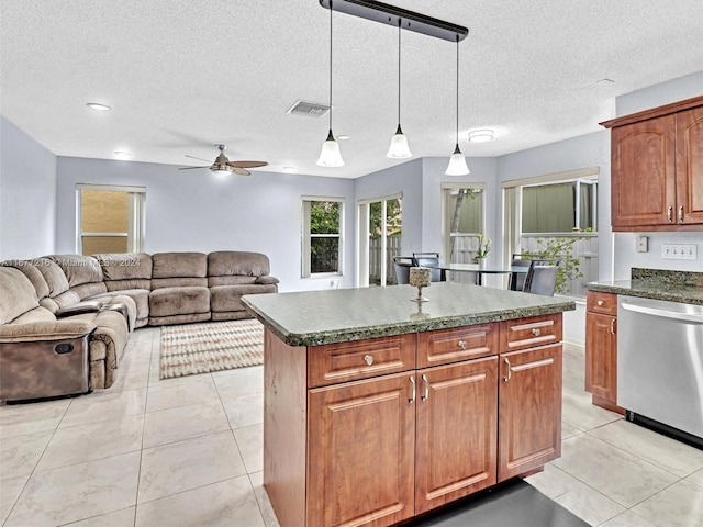 kitchen featuring dishwasher, a textured ceiling, a center island, ceiling fan, and pendant lighting