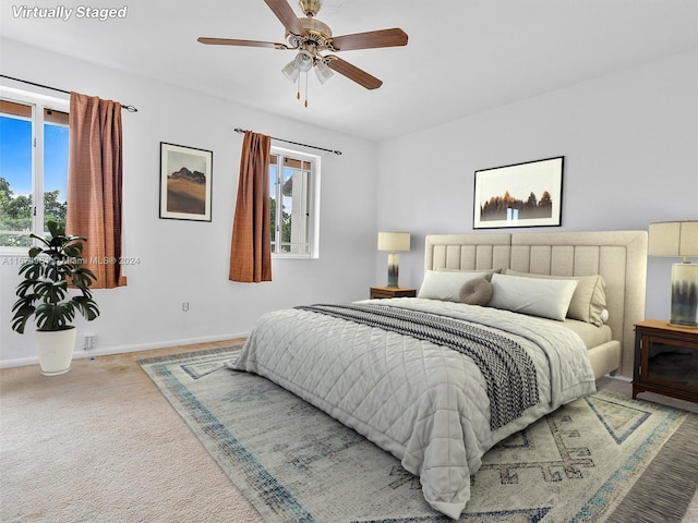 bedroom with ceiling fan and carpet