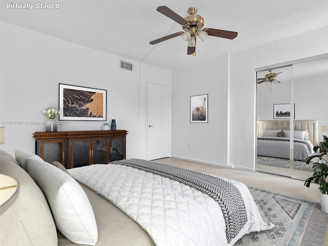 bedroom with carpet flooring, ceiling fan, and a closet