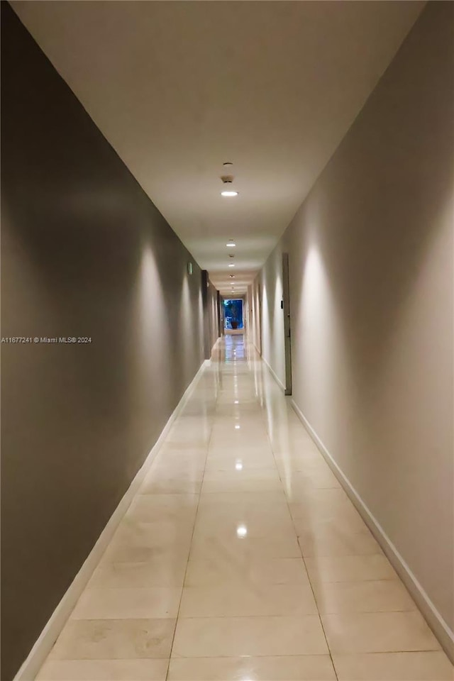 hall with light tile patterned floors