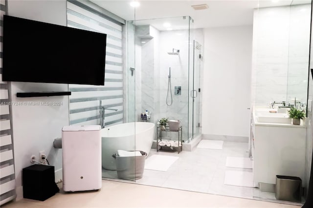 bathroom featuring vanity, tile patterned floors, and separate shower and tub